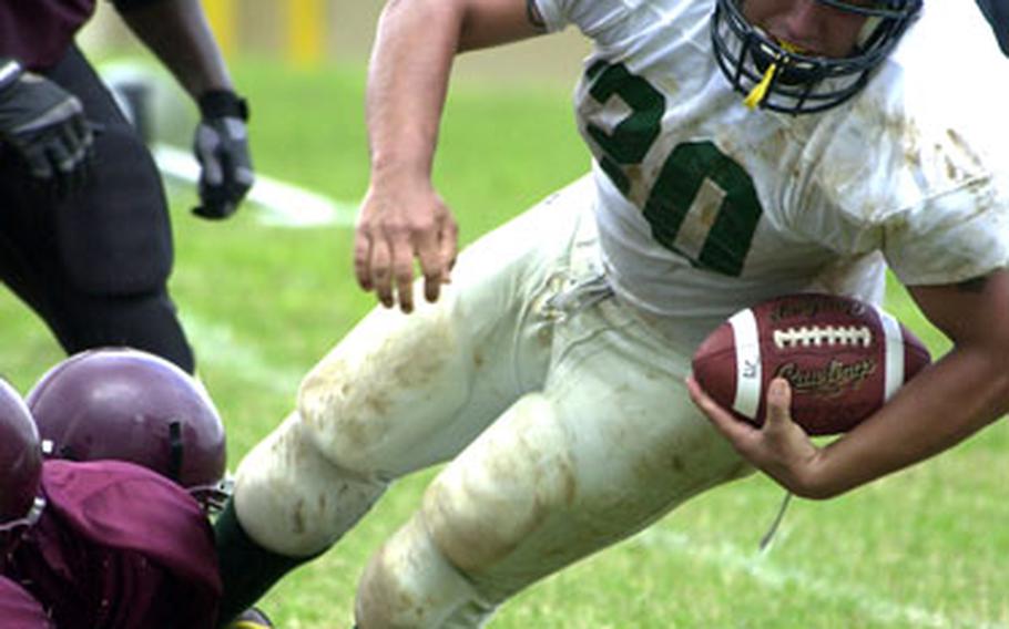 Courtney-Hansen fullback Jesus Lira is felled by a pair of Kinser defenders on Saturday.