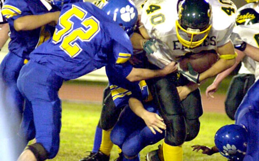 Robert D. Edgren ballcarrier Kevin McDonald (40) is surrounded by the Yokota Panthers defense during Friday’s game at Yokota Air Base, Japan. Yokota routed Edgren to clinch its seventh straight JFL title.