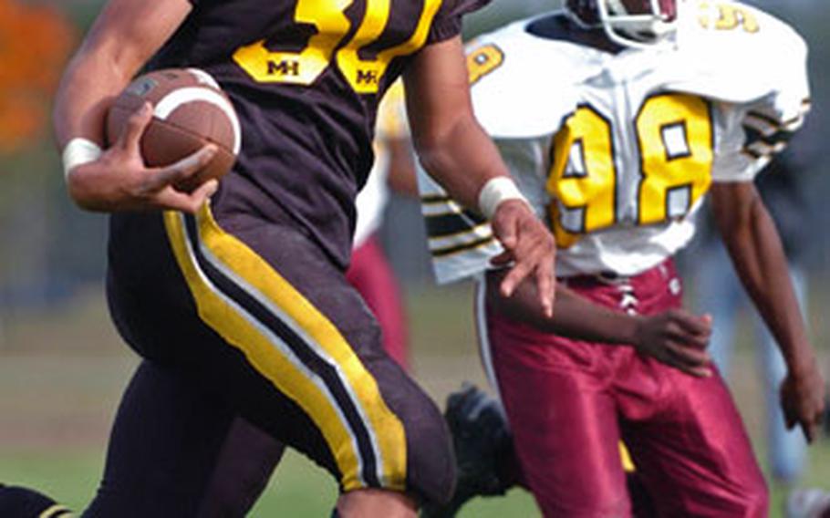 Hanau’s Michael Lewis scampers into the end zone as Baumholder’s Rashad Palmer gives chase. Lewis’ touchdown was negated by a holding penalty.