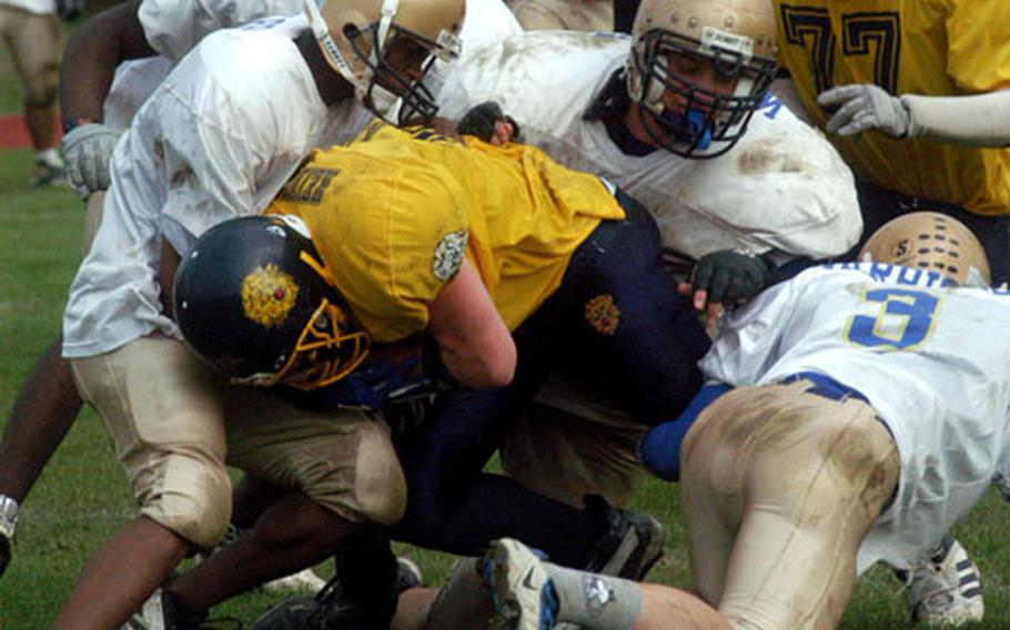 Heidelberg running back Andrew Spellman gets tackled by the Wiesbaden defense Saturday during the fourth quarter of Wiesbaden’s 14-13 victory in Heidelberg, Germany.