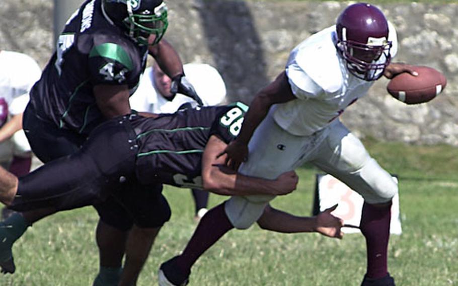 Kadena Dragons defensive end Kevin Carter (98) racks up one of his four sacks of Kinser Knights quarterback Jacksby Sewell during Sunday’s OFL game at Camp Courtney, Okinawa.