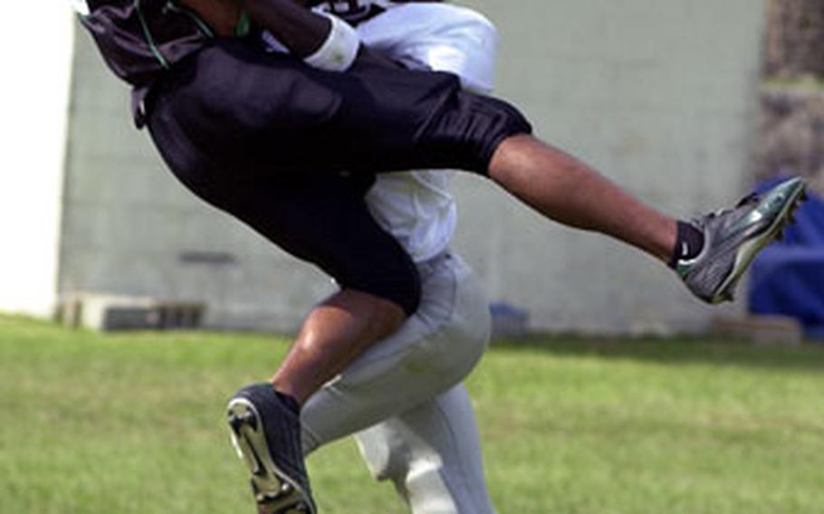 Dragons receiver Eric Lazenby (9) goes high for the ball as Kinser Knights cornerback Jonny Lewis defends. Lewis incurred a pass interference penalty on the play.