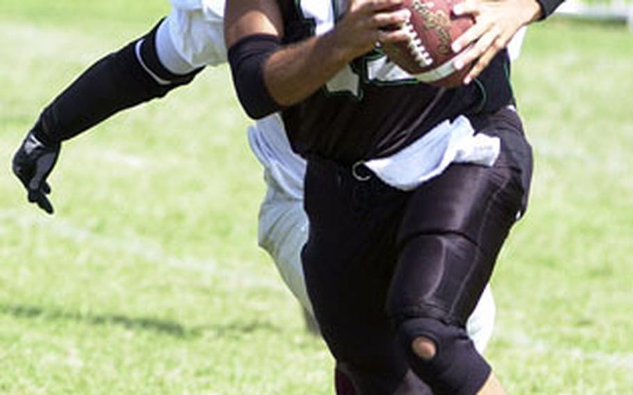 Dragons quarterback Adam Hendrickson eludes the Kinser rush. Hendrickson went 7-for-10 for 114 yards and two touchdowns.