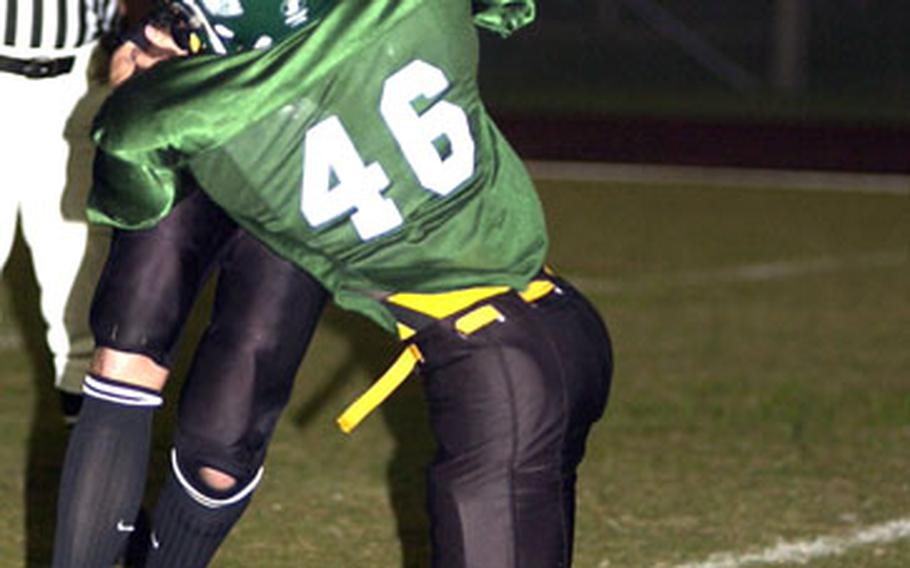 Kadena Panthers quarterback Alex Mierzejewski gets sacked by Terry Hilson of the Kubasaki Dragons during Friday’s third game in the best-of-three Okinawa Activities Council football championship series at Camp Foster, Okinawa. Kubasaki edged Kadena 13-12, clinching the league title.