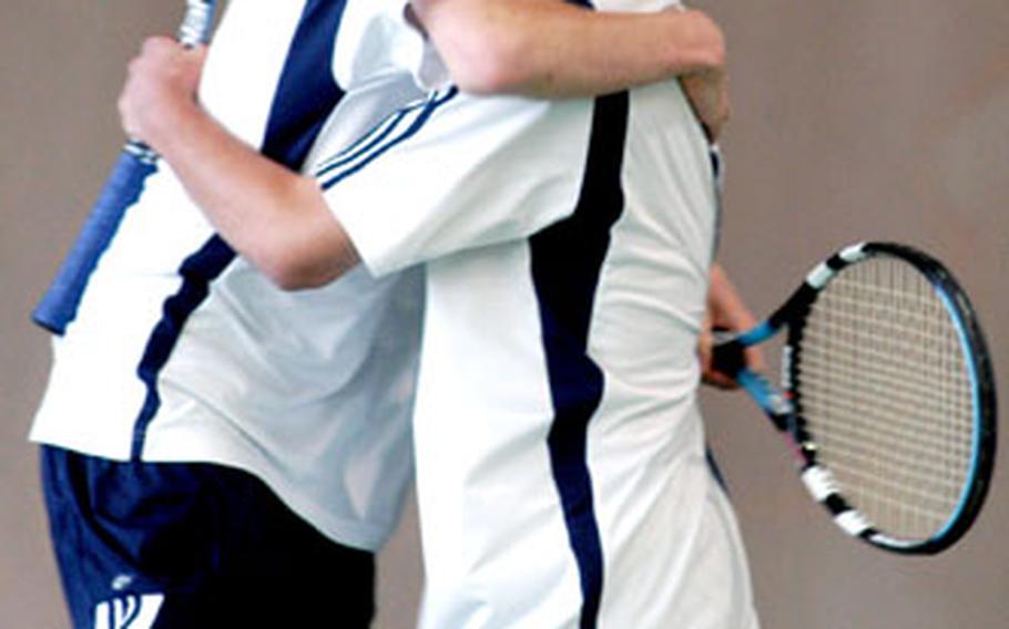 Heidelberg’s Sam Pohl, left, and Blair Martin celebrate their 6-4, 6-7 (8-10), 6-4 victory over top-seeded Phil Burroughs and John Keenan of Lakenheath in the doubles final.