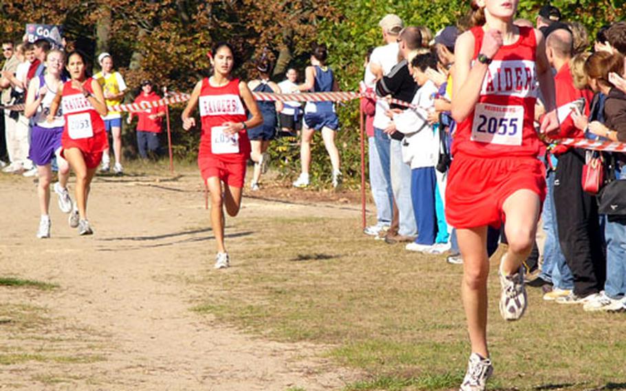 Freshman Colleen Smith of Kaiserslautern leads teammates Joy, center, and Anna Hrushka to the finish line Saturday at the European Big Schools cross country girls championships.