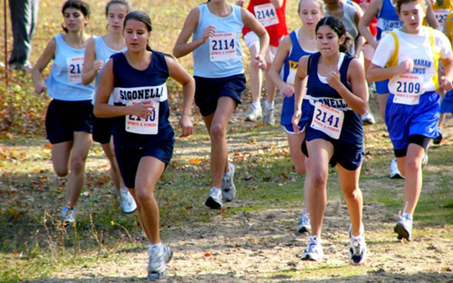 Sigonella’s Ericka Anderson, left front, and her teammate Sammantha Boos took the lead from the outset of the European Small Schools girls cross country championship race.