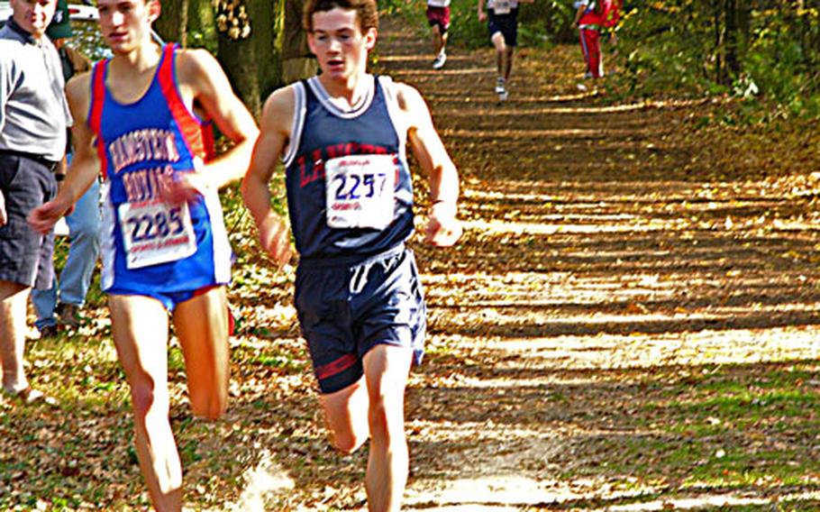 Lakenheath’s Greg Billington, right, stays just ahead of defending champion Danny Edwards of Ramstein Saturday during the European Big Schools championship cross country race Saturday.
