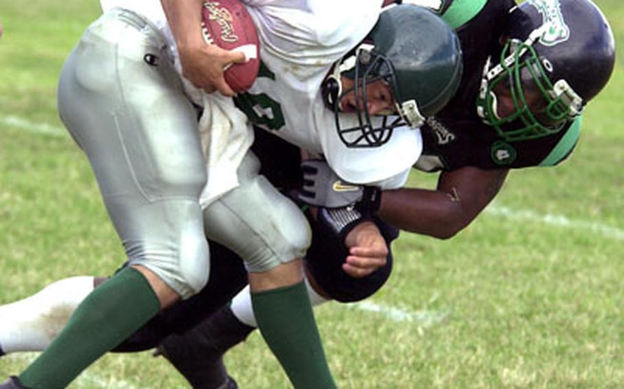 Courtney-Hansen quarterback Juan Garcia is brought down by Kadena defender Leonard Simmons.