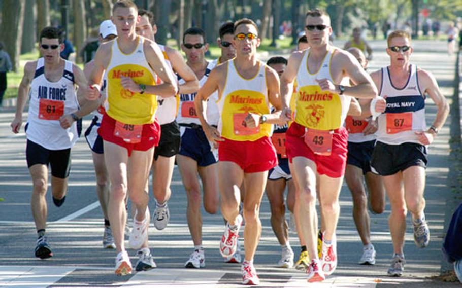 U.S. Marine Corps runners Jeremy Brown (49), William Edwards (41) and Alexander Netherington lead a pack of runners about 14½ miles into Sunday&#39;s Marine Corps Marathon. Brown finished 16th overall; Netherington was 17th and Edwards 18th.
