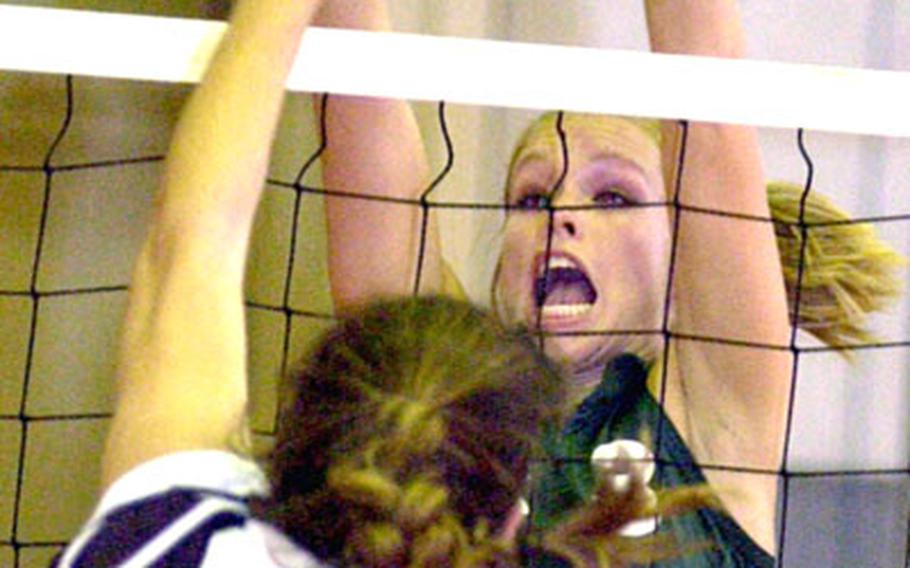 Kubasaki senior middle blocker Alex Fernandez blocks a shot by Erica Kerr of Kadena during Wednesday's volleyball match at Camp Foster. Coach Terry Chumley says Fernandez's skills have helped the Dragons become as strong a team as she's had in her five years at Kubasaki. But track and field, specifically pole vaulting, will likely lure Fernandez back to Woodland High School in California.
