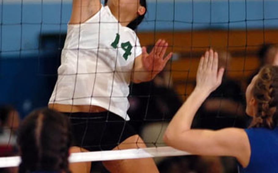 Alconbury’s Kristine Fernandez spikes the ball past by Milan’s Natasha Iannone, left, and Elizabeth Cash during the final match of the DODDS-Europe Division IV volleyball championships in Ramstein, Germany, on Saturday. Alconbury won 25-9, 19-25, 25-14, 25-14.