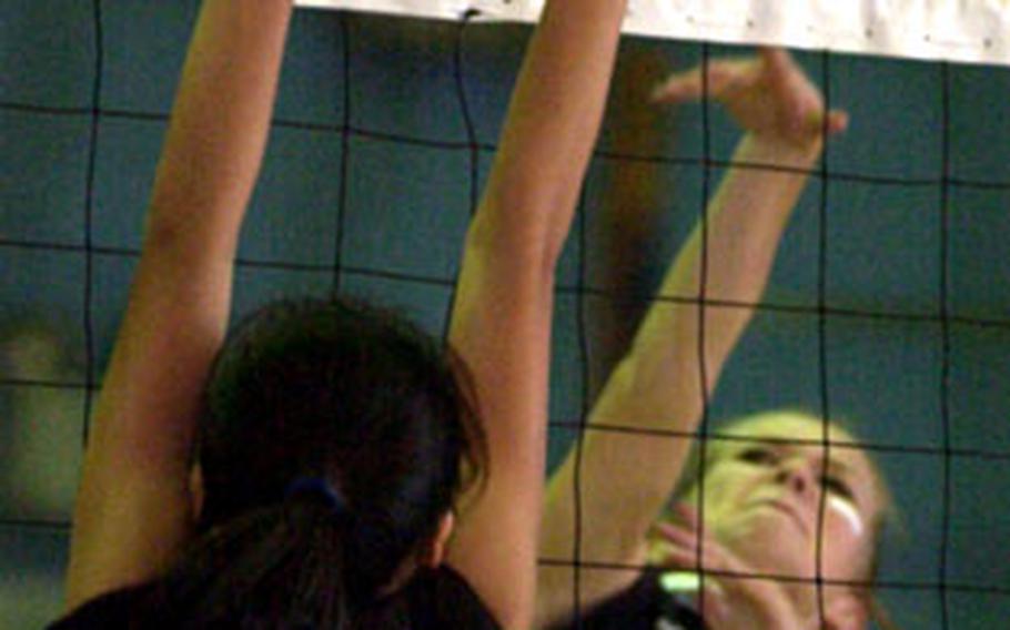 Kate Shicks of Zama American blasts a spike through the block of Monica Malig (12) of Simon during the Far East Girls Class AA Volleyball Tournament on Monday at Yongsan Garrison, South Korea. Zama swept the Sharks 25-16, 25-21.