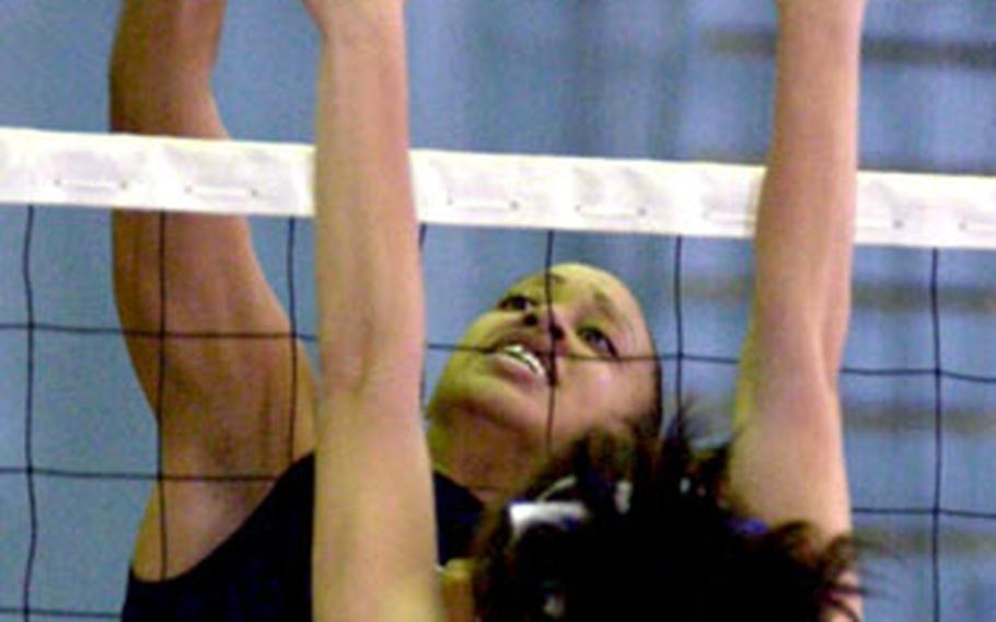 Margaret Nurse of Seoul American spikes through the block of Kelsey Masuda (21) of Christian Academy In Japan during Monday’s pool play. The Knights swept Seoul 25-18, 25-14.