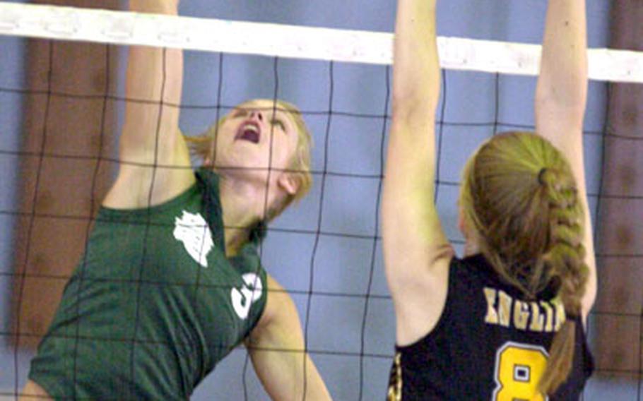 Kubasaki senior Alex Fernandez goes up to spike past Sarah Englin of the American School in Japan during Tuesday&#39;s divisional play in the 2005 Far East High School Girls Class AA Volleyball Tournament. Fernandez had six spike kills and five block points as Kubasaki edged ASIJ 25-23, 25-20.