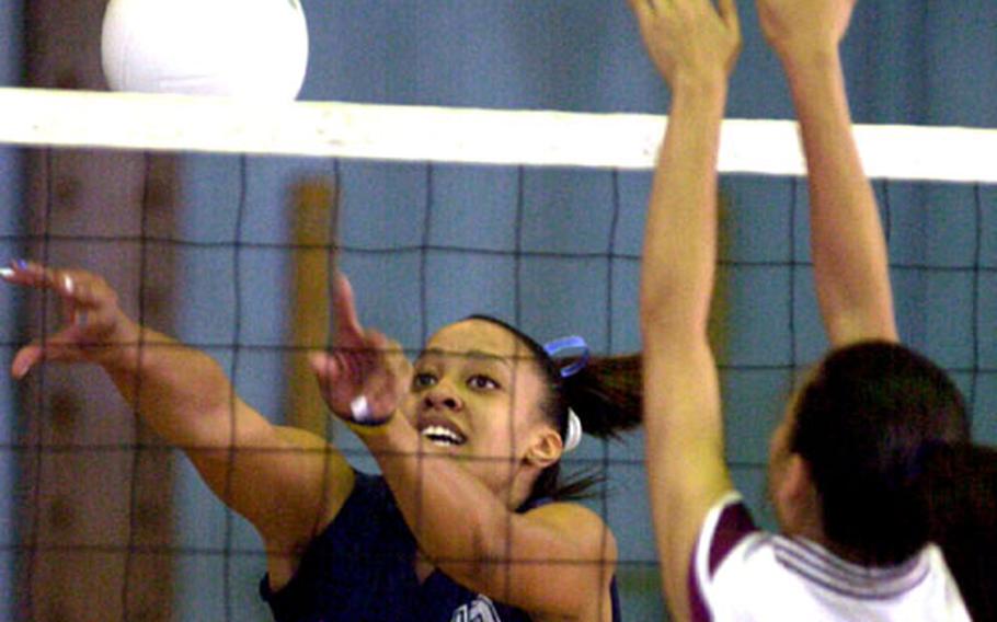 Seoul American middle blocker Margaret Nurse (13) pushes the ball past the block of Seisen International defender Jessica Eastling (6) during Wednesday&#39;s divisional play in the 2005 Far East High School Girls Class AA (large schools) Volleyball Tournament at Yongsan Garrison.
