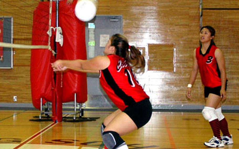 E.J. King’s Elicia Castro hits a set-up shot as Christina Rennick looks on Friday during a contest against Edgren High School in the Far East Class A volleyball tournament on Friday at Sasebo Naval Base, Japan.