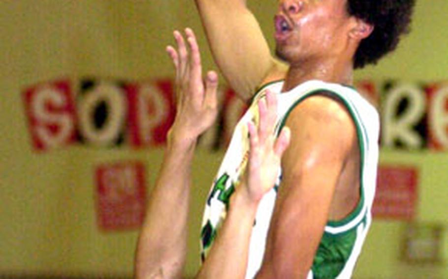 Kubasaki Dragons center Vance Maxey goes up for a shot over a Konan Shisa defender during Friday’s Okinawa-American League boys basketball game at Kubasaki High School, Camp Foster, Okinawa. Maxey scored 29 points as the Dragons outlasted Konan 112-107.