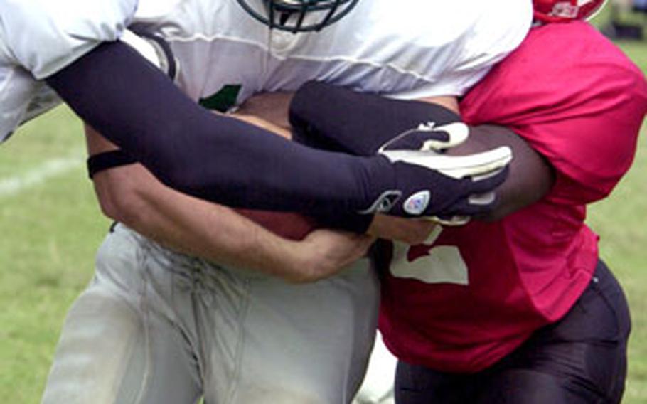 Titans fullback Jesse Hampton is tackled by Bulldogs defender Michael Lawson for a 4-yard loss.