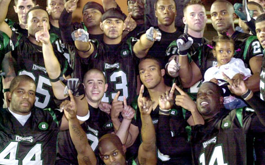 Kadena Dragons players celebrate their second straight Okinawa Football League championship Saturday at Camp Foster, Okinawa. The Dragons romped 45-7 over the Courtney-Hansen Titans.