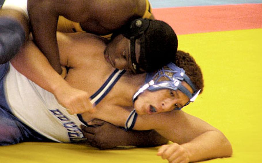 Heidelberg’s Brandon Simmons digs deep Saturday while trying to maintain control of Eric Popp of Brussels in the late going of the pair’s 215-pound title bout in the Wolfpack Holiday Classic wrestling tourney.