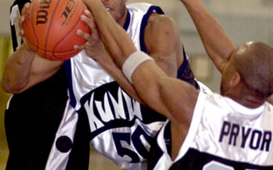 Samuel Dixon (50) of the Kunsan Air Base Wolf Pack collides with defenders Matthew Long and Jamie Pryor (33) of the Camp Humphreys Bulldogs on Tuesday at Yongsan Garrison, South Korea.