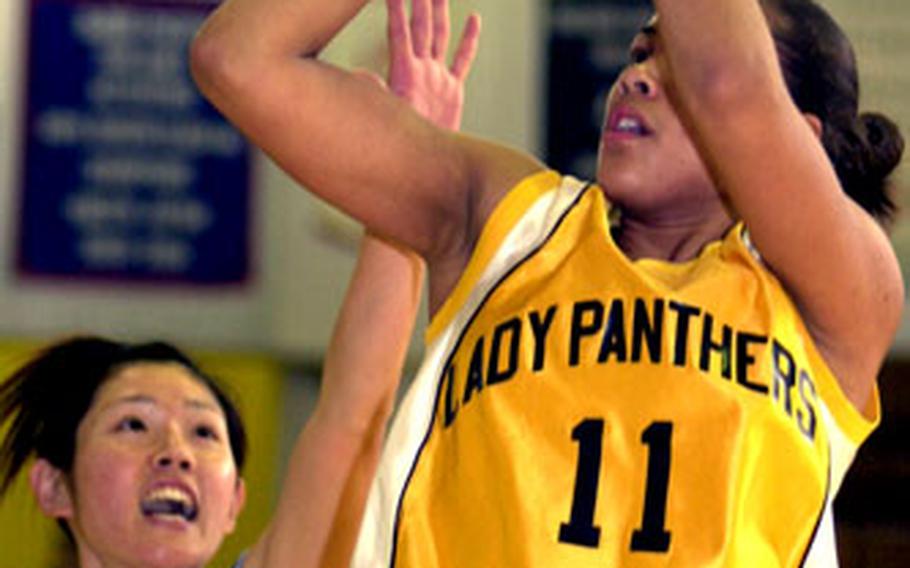 Kadena Panthers senior Liz Cotto puts up a shot past Shinobu Hakushi of BC Sports, a Japanese club team, during Saturday’s girls basketball game at Kadena Air Base, Okinawa. Kadena won 81-76.