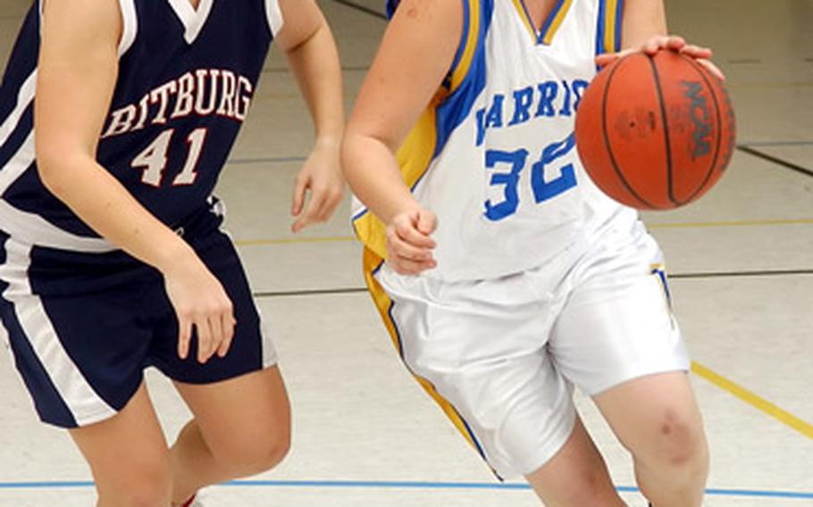 Wiesbaden’s Nancy Jensen drives the lane past Bitburg’s Jennica Botonis during a DODDS-Europe high school basketball game in Wiesbaden, Germany, on Friday. Wiesbaden defeated Bitburg 37-32.