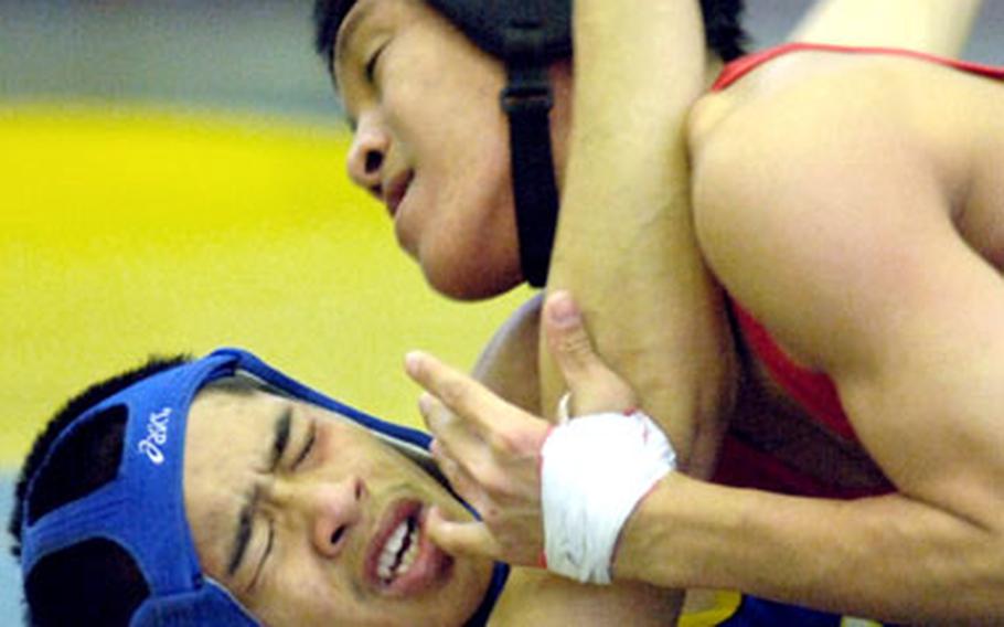 Bobby Antonio of Nile C. Kinnick pins Patrick Pamintuan of Yokota in 1 minute, 35 seconds in the 115-pound chanmpionship match. It was Pamintuan’s first loss in in one-and-a-half seasons.