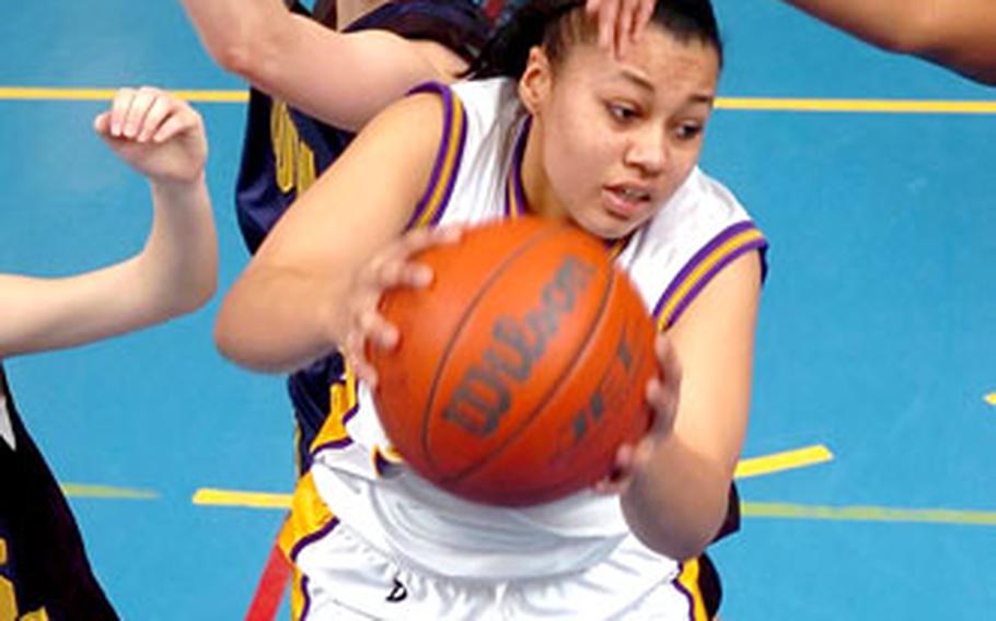 Würzburg’s Ashley Hicks snags a rebound in front of Heidelberg’s Kat Schultz during a DODDS-Europe high school basketball game in Heidelberg, Germany, on Saturday. Würzburg won, 36-28.