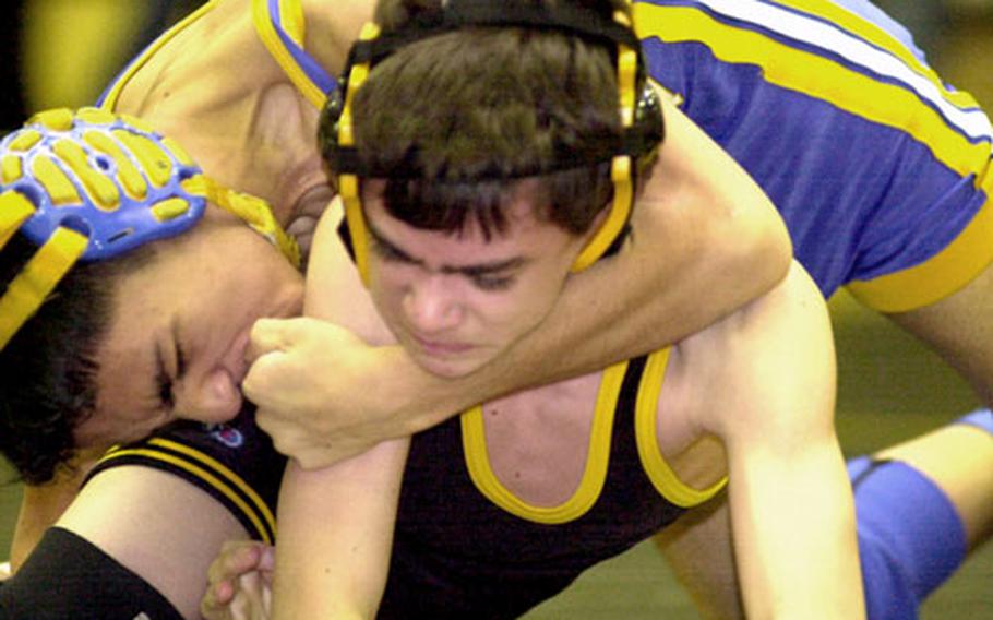 Nick Guzman of the Yokota Panthers ties up Chris Lowry of the American School In Japan Mustangs during Wednesday’s 108-pound bout.