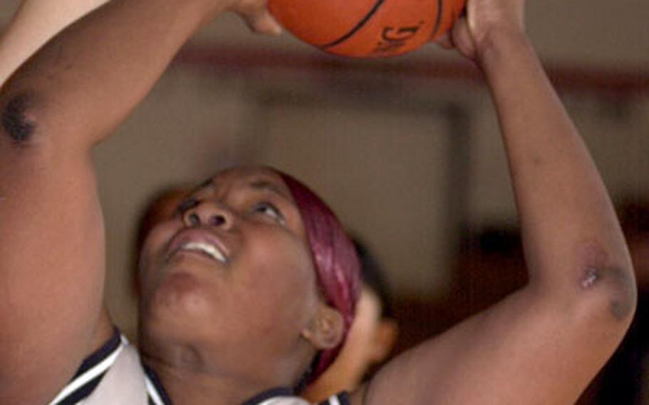 Zama American senior Tiffani Wright takes a shot during Friday&#39;s game against the International School of the Sacred Heart. Wright had 28 points, 14 rebounds and four blocked shots in a losing cause as the Symbas scored the last 12 points to rally past the Trojans, 52-45.