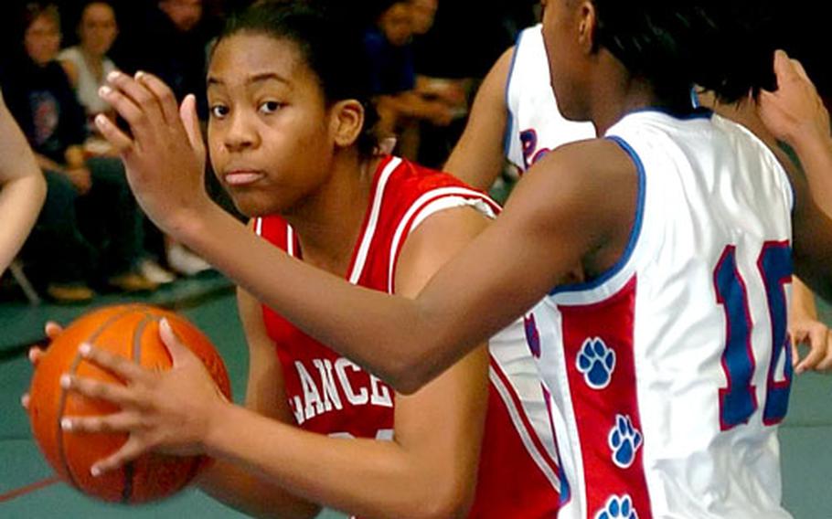 Lakenheath’s Angelia Gafford tries to get around Ramstein’s Kendra Lenoir on Saturday in Ramstein, Germany. Lakenheath defeated Ramstein 42-39.