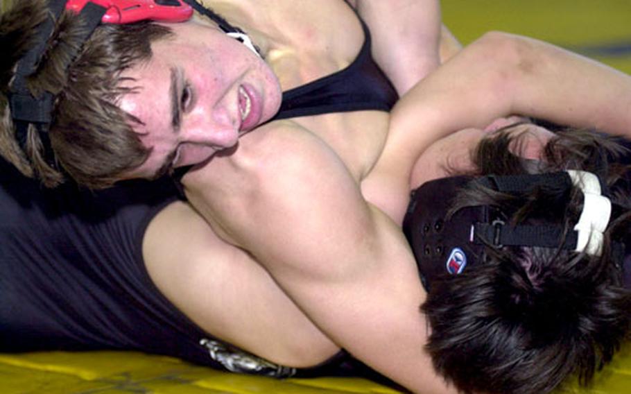 David Heitstuman of E.J. King cradles the shoulders of Zama American’s Josh Johnson to the mat in the 129-pound championship bout at Saturday’s DODDS-Japan tournament at Yokota Air Base, Japan. Heitstuman won by pin.