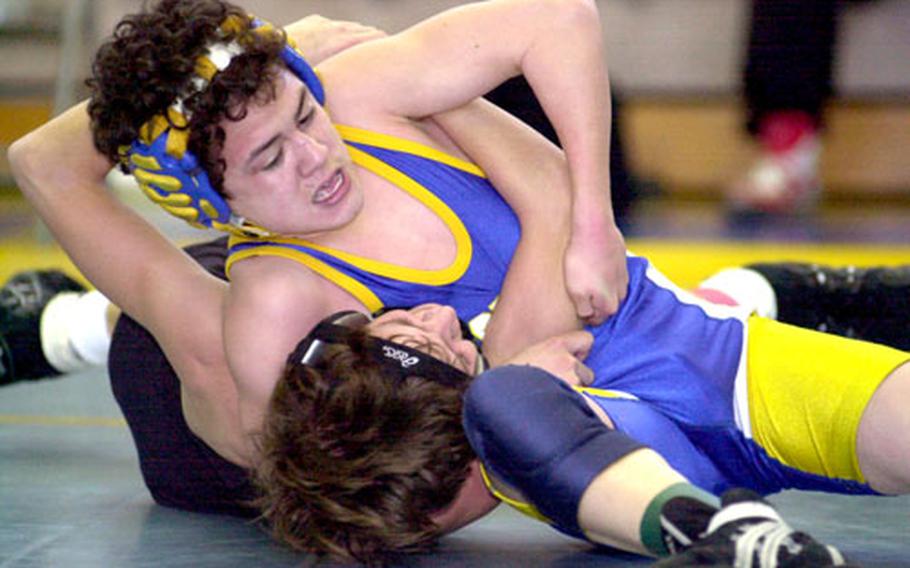 Freshman Mark Meade of the Yokota Panthers gets Kevin Donahue of the E.J. King Cobras in a head-in-arm hold during Saturday’s 101-pound final of the DODDS-Japan wrestling tournament at Yokota Air Base, Japan. Meade, who plans to stay at Yokota until he graduates, won and captured the gold medal.