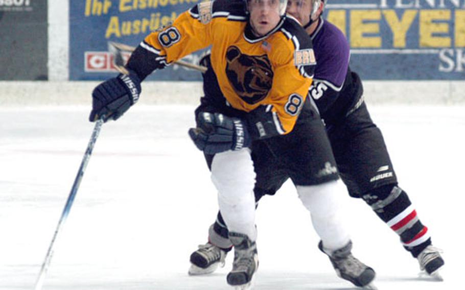 Baden's Remi Johnson is pursued by Bitburg's Terry Courtney during Friday's title game at the 14th Annual USAFE Ice Hockey Championships in Garmisch, Germany. Bitburg won, 4-2.