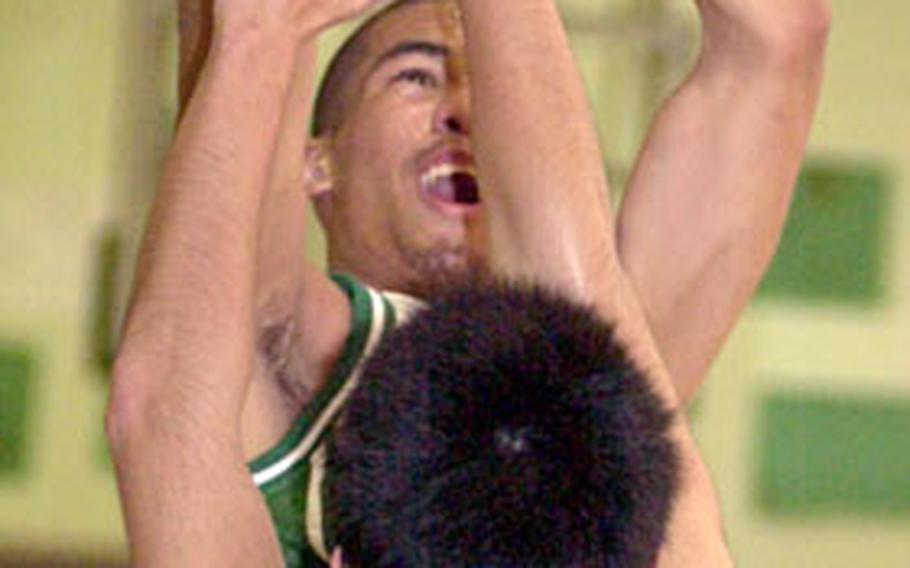 Senior Vance Maxey of the Kubasaki Dragons tries to shoot over Mirai Technical defender Daisuke Tokumori during Friday’s Okinawa-American League boys basketball game at Kubasaki High School, Camp Foster, Okinawa. Maxey had a game-high 30 points in the 109-92 Kubasaki vistory.