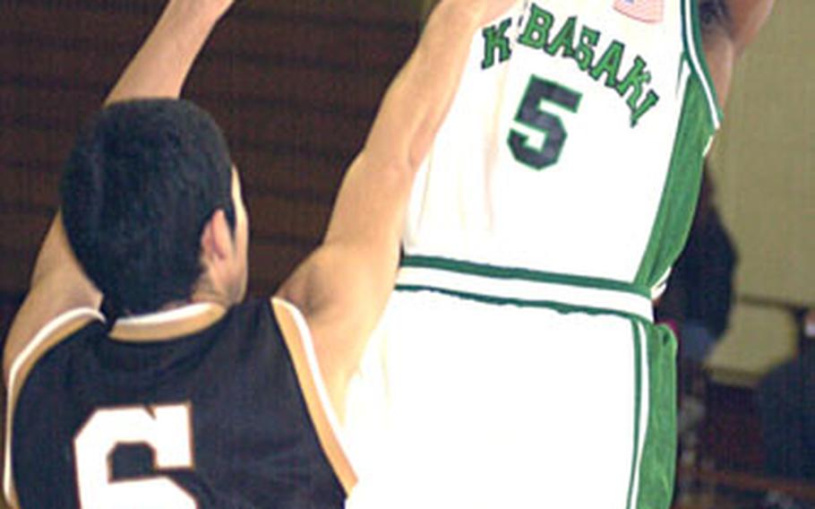 Kubasaki senior Steven Ellis shoots over Mirai Technical defender Shota Noborikawa.