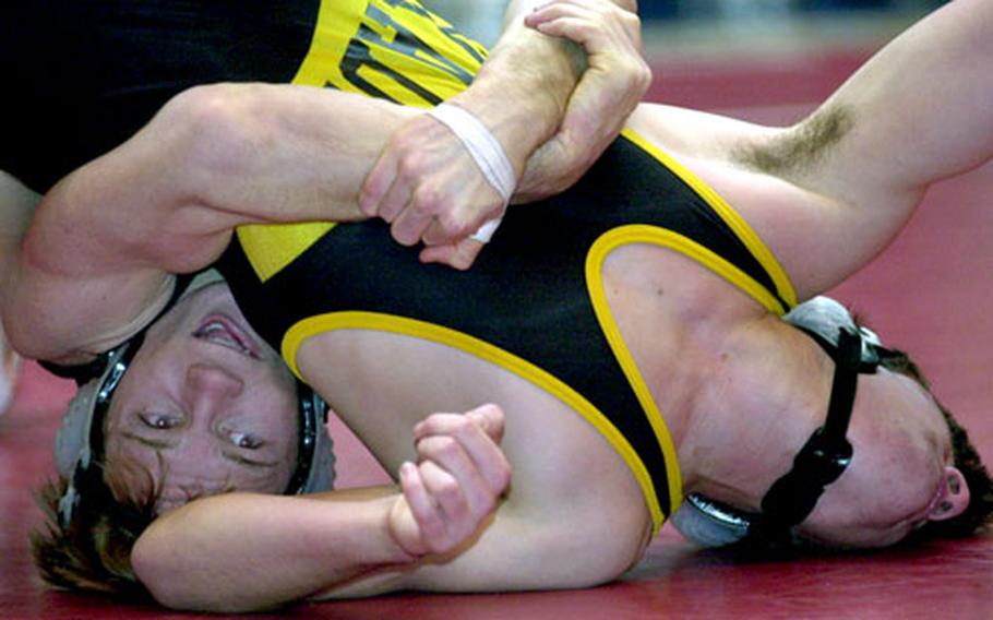 Steve Courtney, left, of Kubasaki gut-wrenches Ian Copeland of Kadena for a two-point tilt during the 158-pound gold-medal bout. Courtney decisioned Copeland 2-0 and was named the tournament’s Outstanding Wrestler.