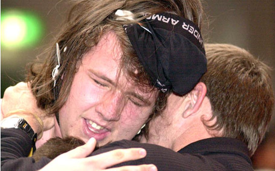 Kadena heavyweight Trey Marks embraces coach Steve Schrock after Saturday’s championship in the dual-meet portion of the 2006 Far East High School Wrestling Tournament at Old Thew Gym, Yokosuka Naval Base, Japan.