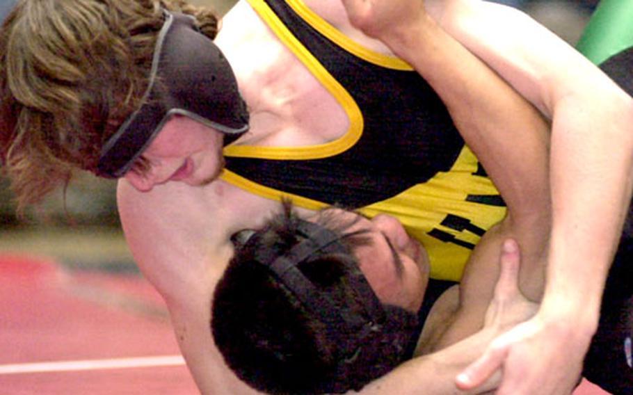 Kadena 135-pounder Brandon McCullough gets C.J. Tapang of Kubasaki in a head-in-arm hold during Saturday’s championship match. McCullough pinned Tapang in 3:57.