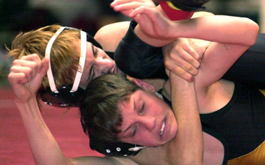 Kubasaki 108-pounder Coty Hampton cradles the shoulders of Kadena’s Chris Hoshaw to the mat during Saturday’s championship match. Hampton pinned Hoshaw in 1:08.