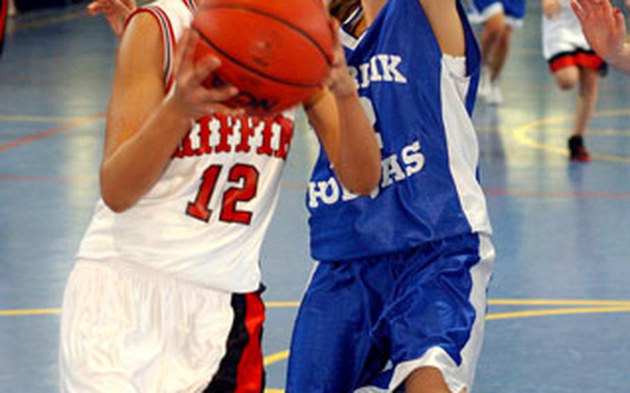 Giessen’s Elishea Darby,goes to the basket against Incirlik’s Melisa Siedow in a Division IV matchup.