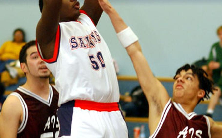 Aviano’s Edmond Johnson shoots over AFNORTH’s Jason Branch, right, as Michael Chase watches the action. Top-seed Aviano beat AFNORTH, 59-19, in an opening day Division II game.