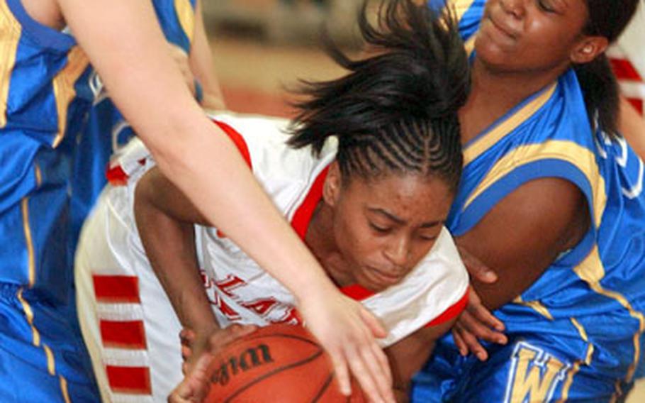 Wiesbaden's Nancy Jensen, left, and Monique Hall tie up Kaiserslautern's Lynndsey Hyter during the first Division I semi-final game at the 2006 DODDS European basketball tournament in Mannheim on Thursday. Kaiserslautern beat Wiesbaden 71-48 to advance to Friday's championship game.
