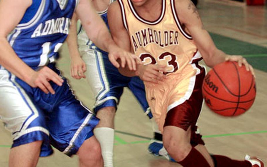 Baumholder's C.J. Roberts drives against Rota's Zach Hudson in opening-day action for Division III at the 2006 DODDS European basketball finals. Baumholder beat the defending champions, 54-33.