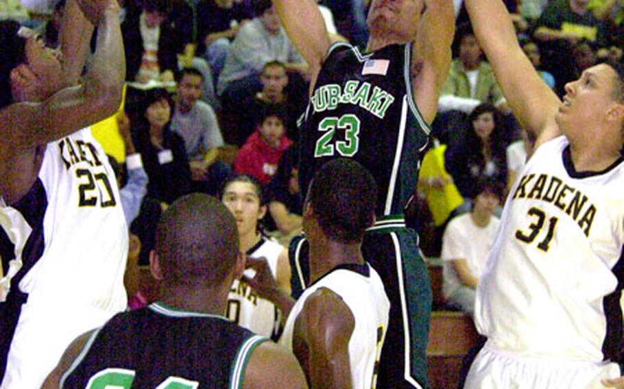 Kubasaki&#39;s Vance Maxey goes up for a shot in the paint as Kadena&#39;s De Williams, No. 31, goes for the block during the teams&#39; Thursday match-up in the Boys Class AA tournament on Kadena Air Base, Okinawa. Kadena won, 61-59.