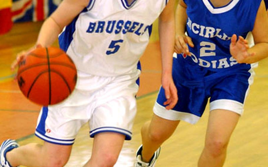 Michelle Rosas of Brussels drives by Alexis Nichols of Incirlik in the Division IV final at the 2006 DODDS European basketball championships at Mannheim on Friday. Brussels took the crown with a 36-23 victory.