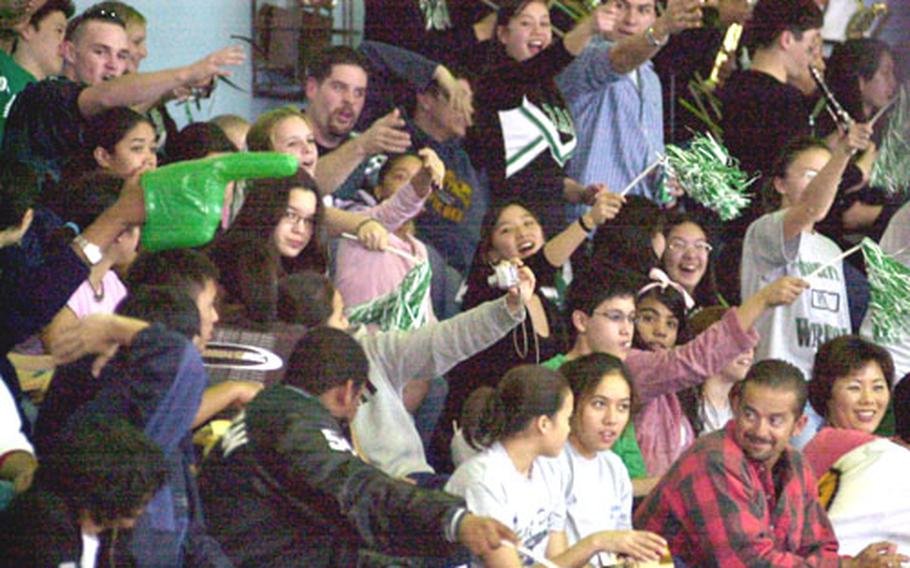 Taegu American Warriors fans do the "Tomahawk Chop" during Friday&#39;s championship game. Taegu rallied from a 25-16 third-quarter deficit to win the first Class A hoops title in school history.