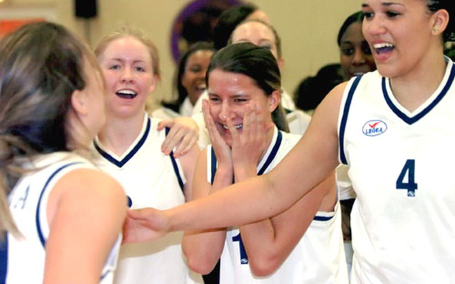 Sigonella players celebrate their victory over Baumholder in the DODDS-Europe girls Division III championship game.